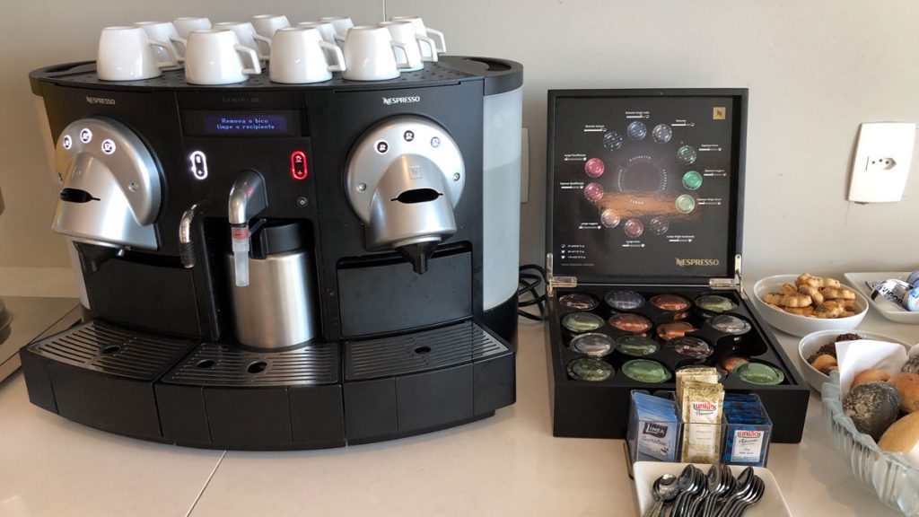 a coffee machine with a box of coffee capsules