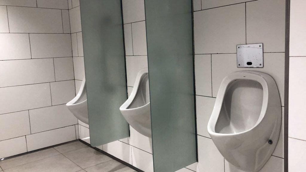 a row of urinals in a bathroom