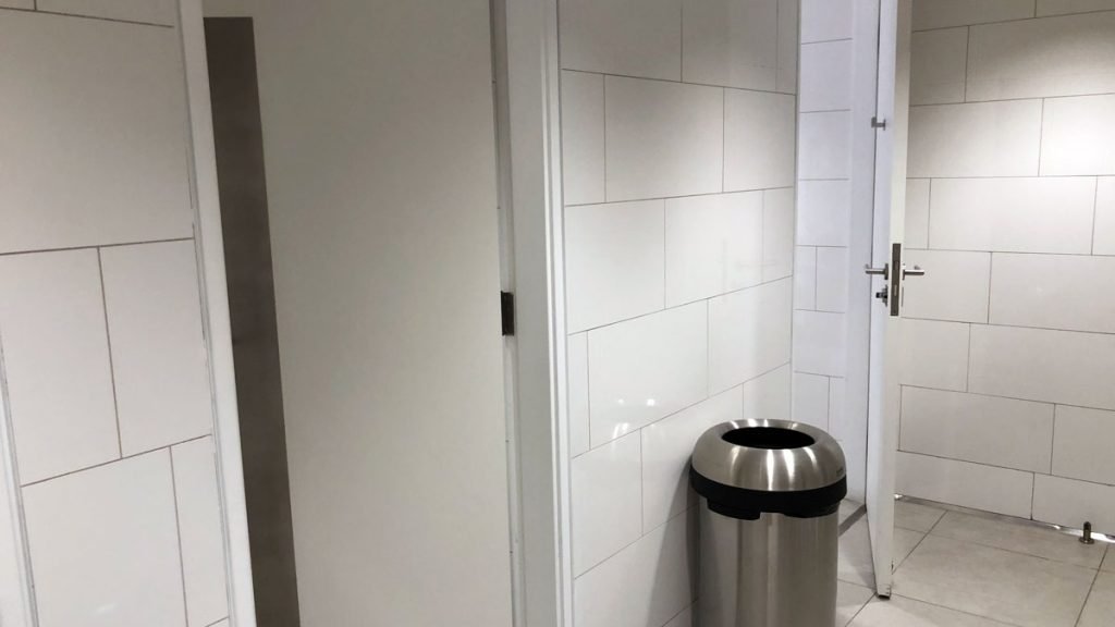 a trash can next to a door