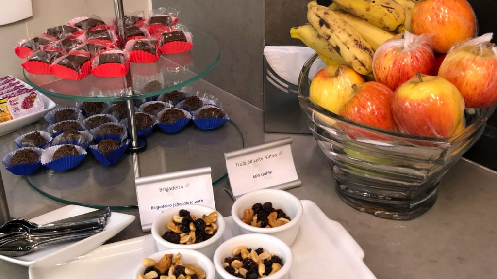 a bowl of fruit and nuts on a table