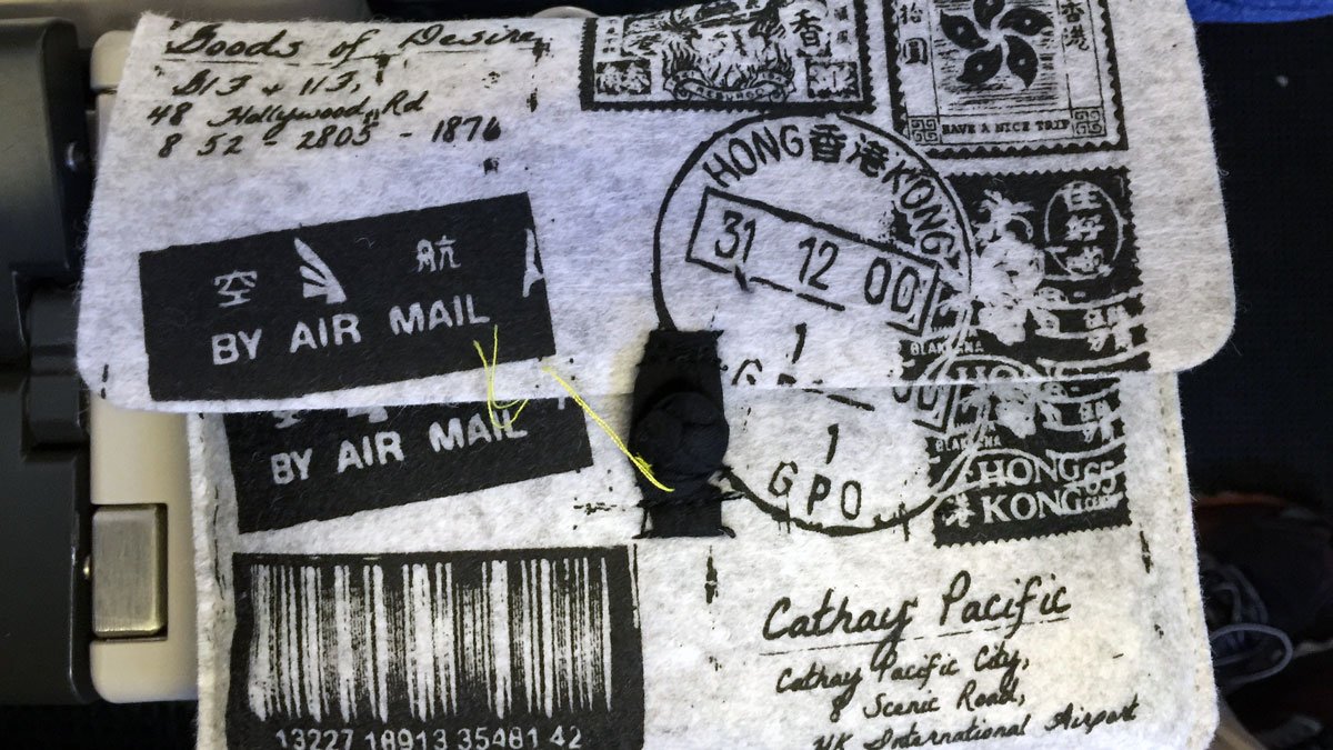 a piece of fabric with stamps and a thread
