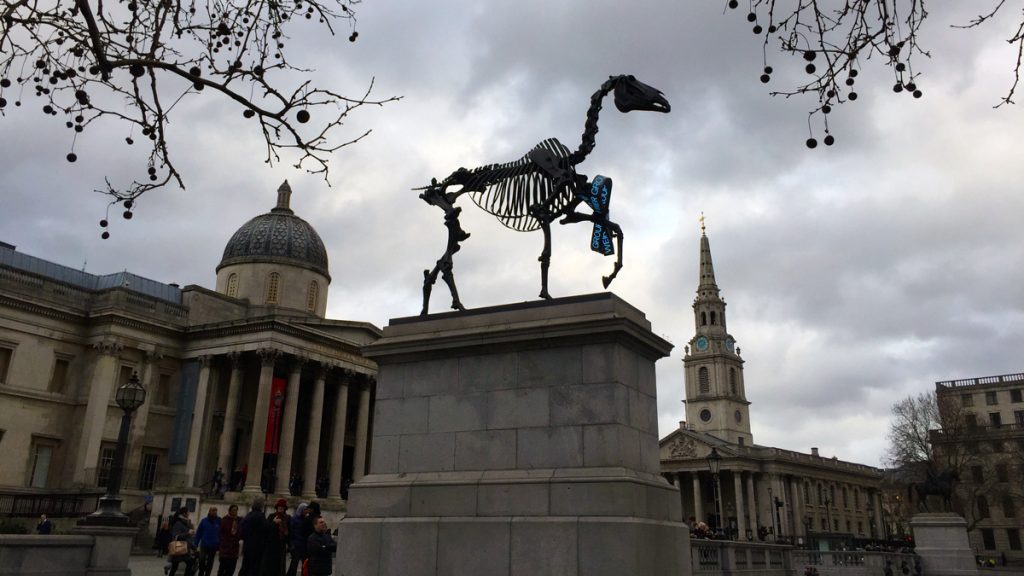 a statue of a horse in front of a building