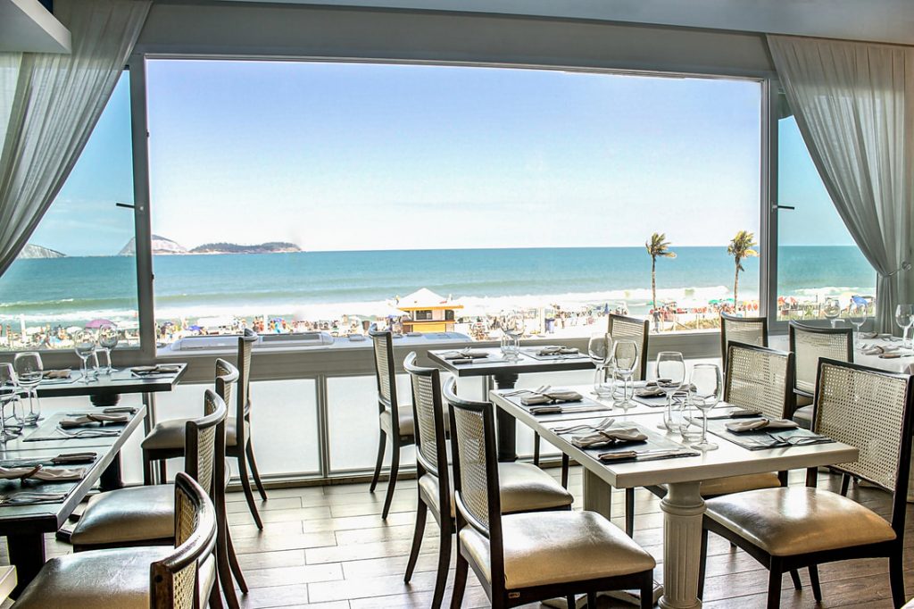 a room with a large window overlooking the ocean