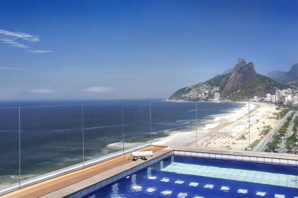 a pool overlooking a beach