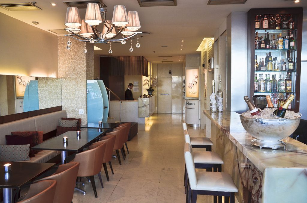 a restaurant with a chandelier and tables