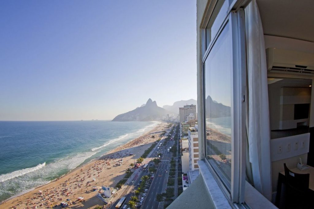 a window overlooking a beach and a city