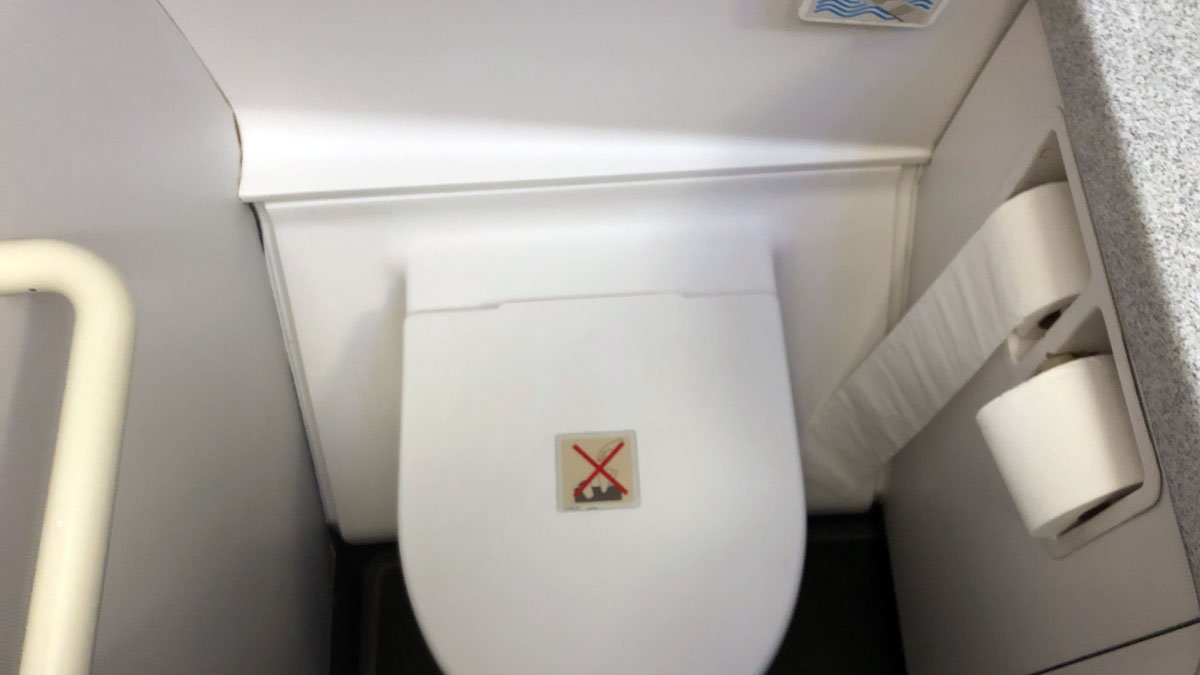 a toilet with a sticker on the lid