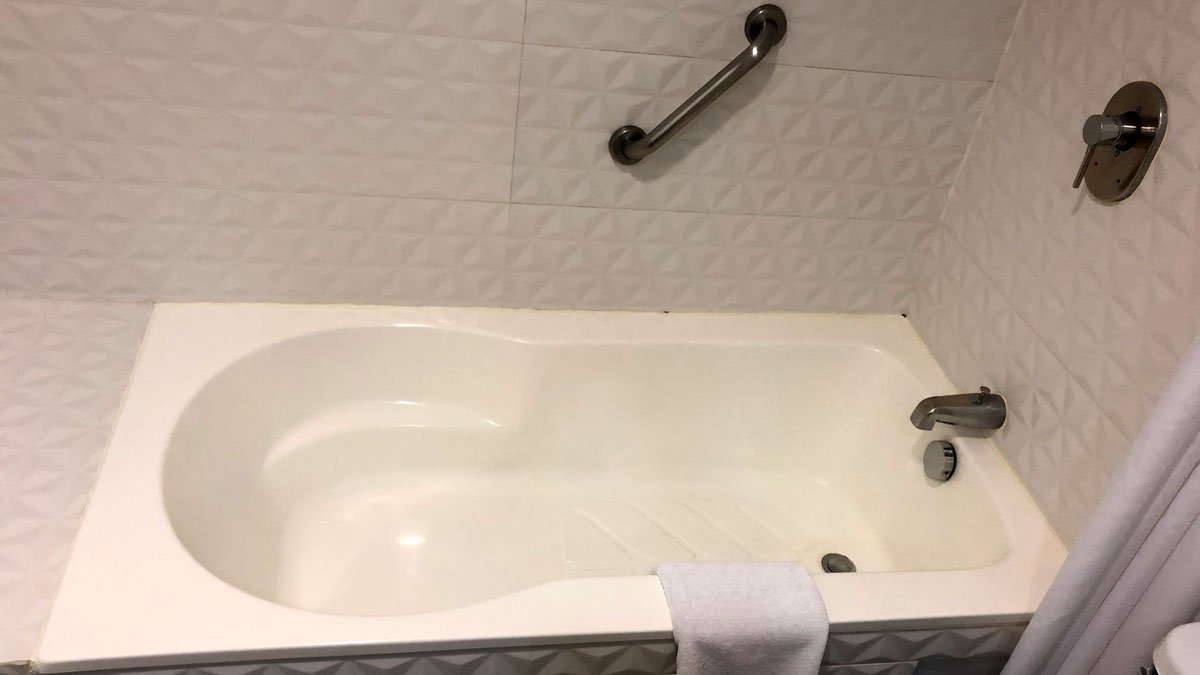 a bathtub with a towel on the side