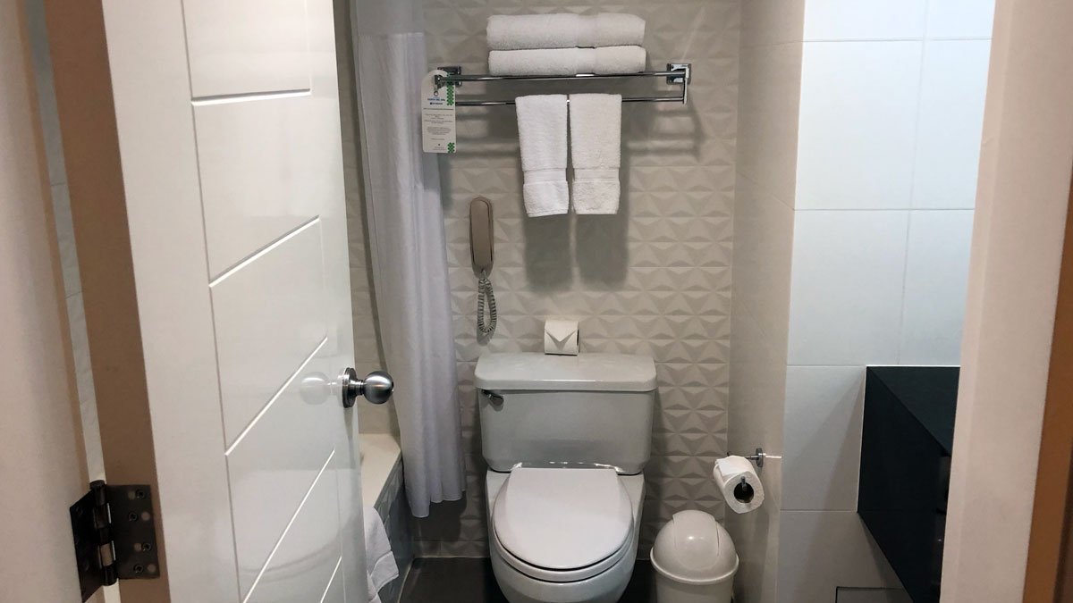 a bathroom with a phone and towels
