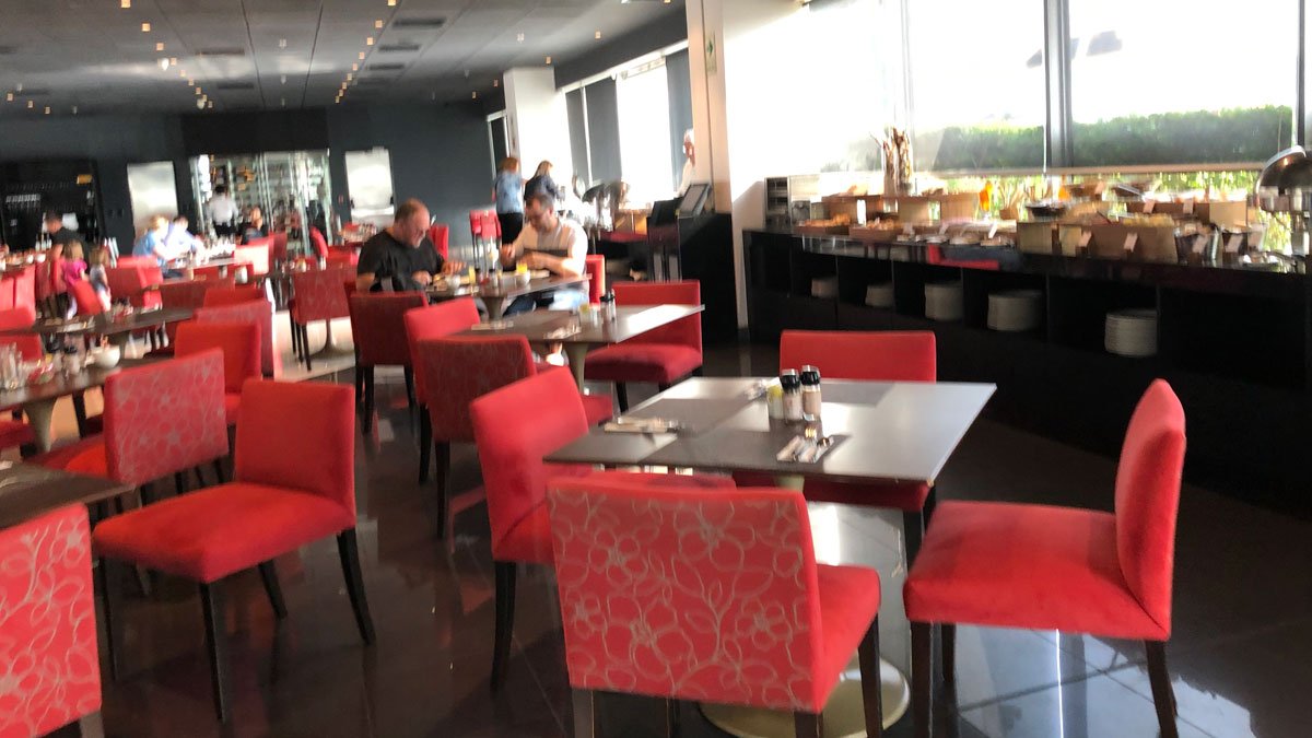 a group of people sitting at tables in a restaurant