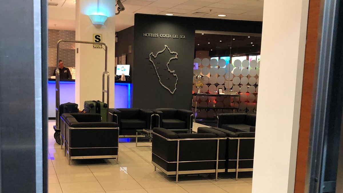 a lobby with black chairs and a map of the country