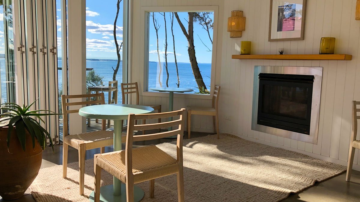 a room with a fireplace and a table and chairs