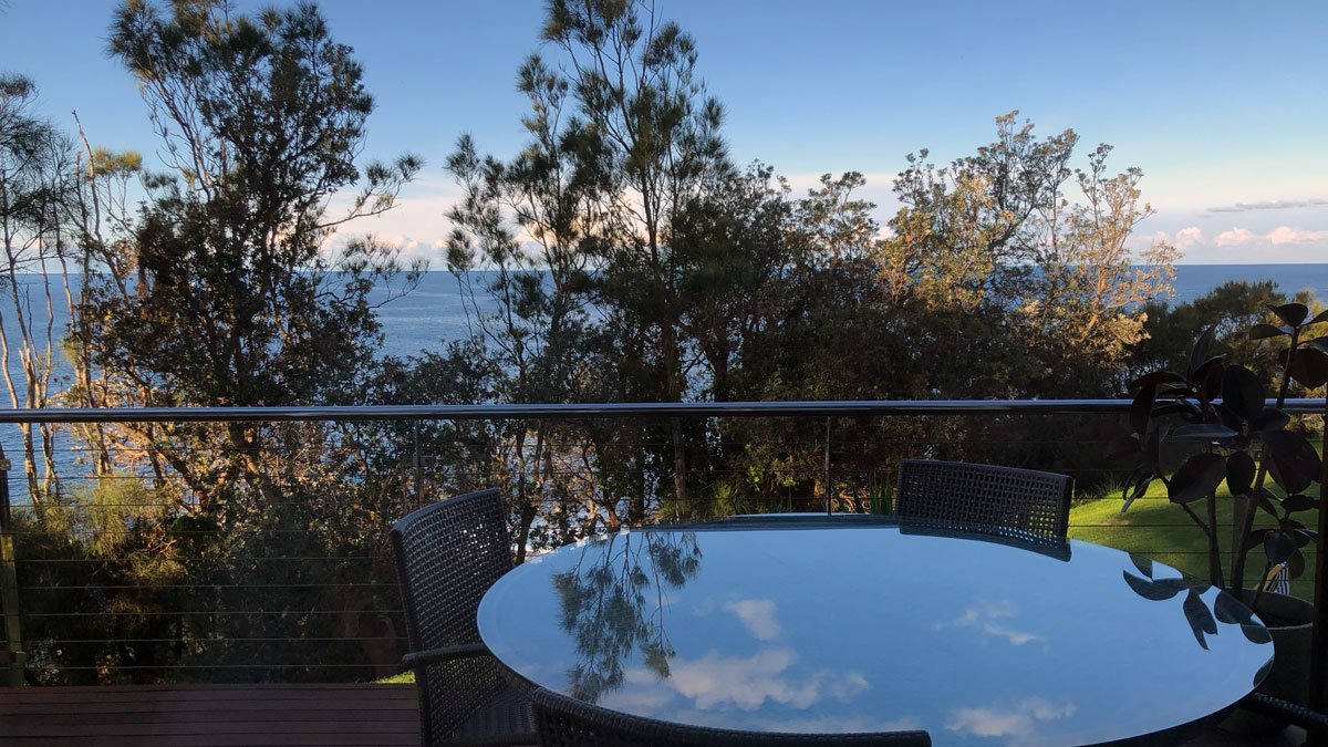 a table and chairs overlooking a body of water