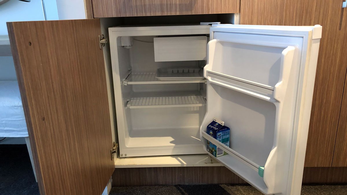 a small refrigerator with a door open