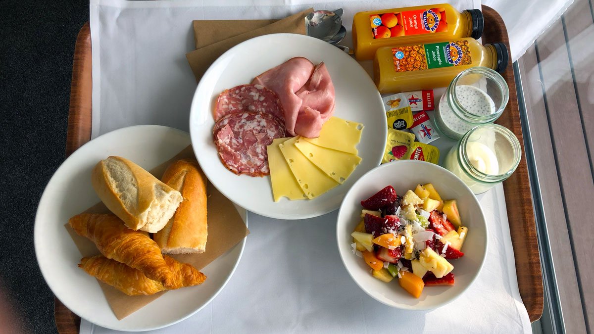 a plate of food and a bowl of juice