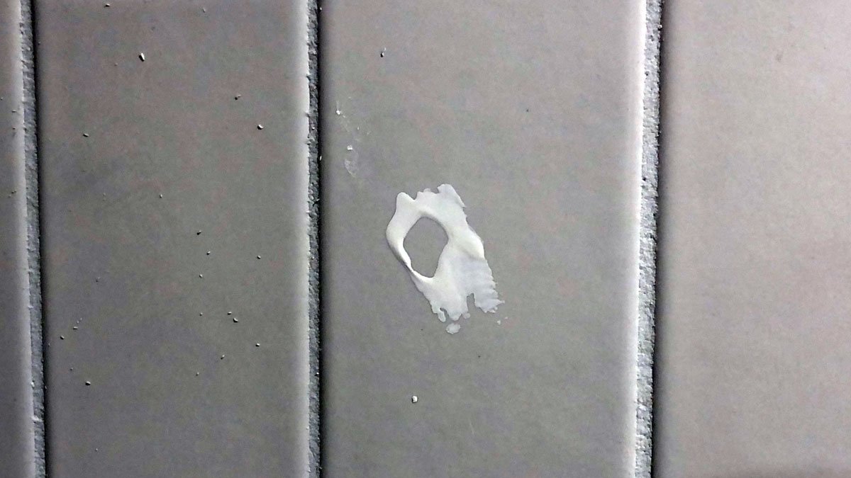 a white spot on a tile surface