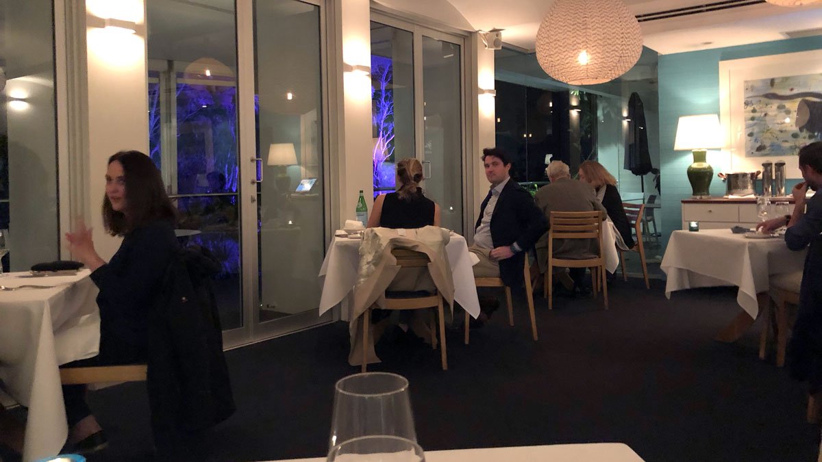 a group of people sitting at tables in a room