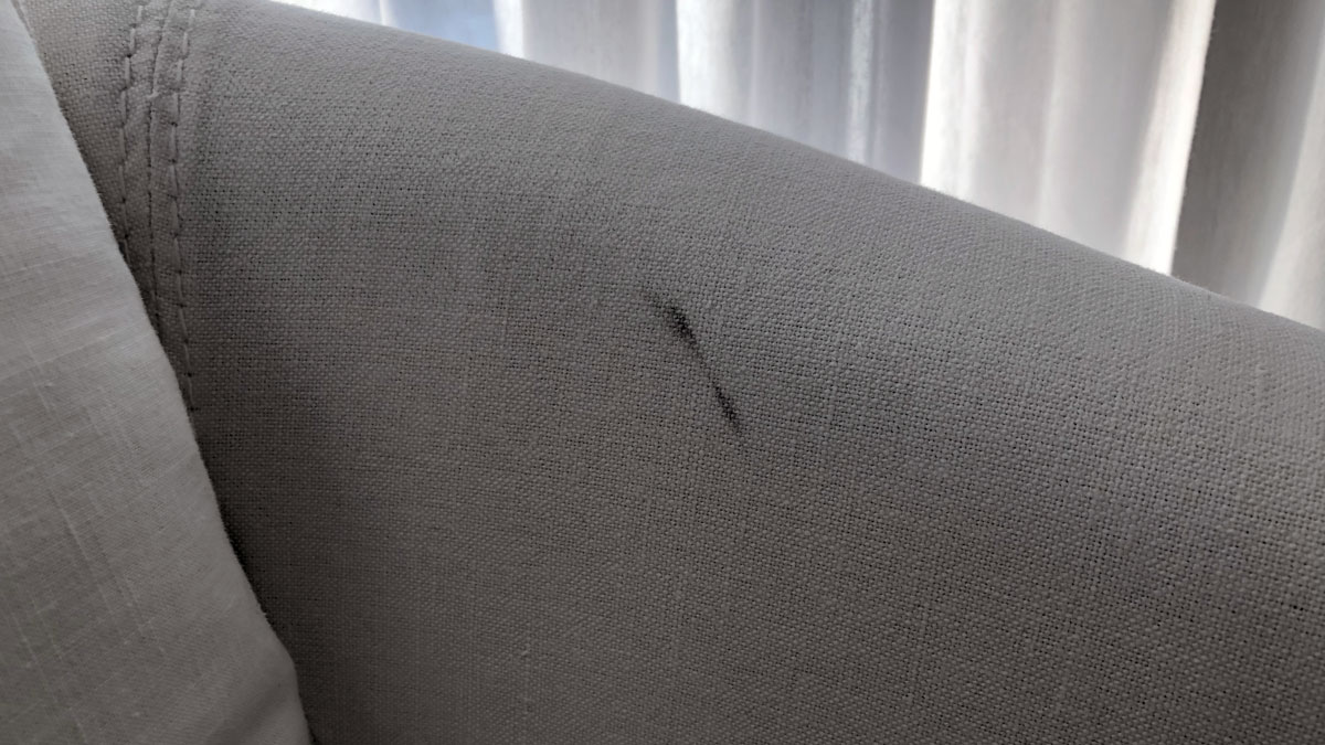 a black mark on a white fabric surface