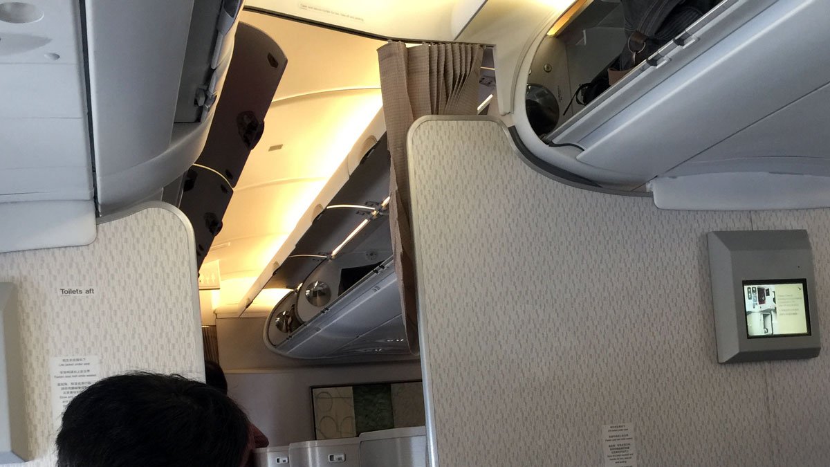 a person looking at a shelf on an airplane