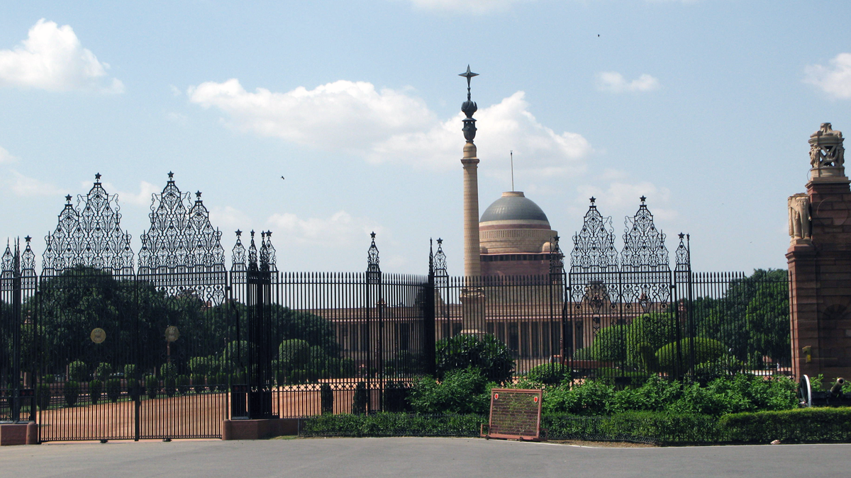 a fence with a building behind it