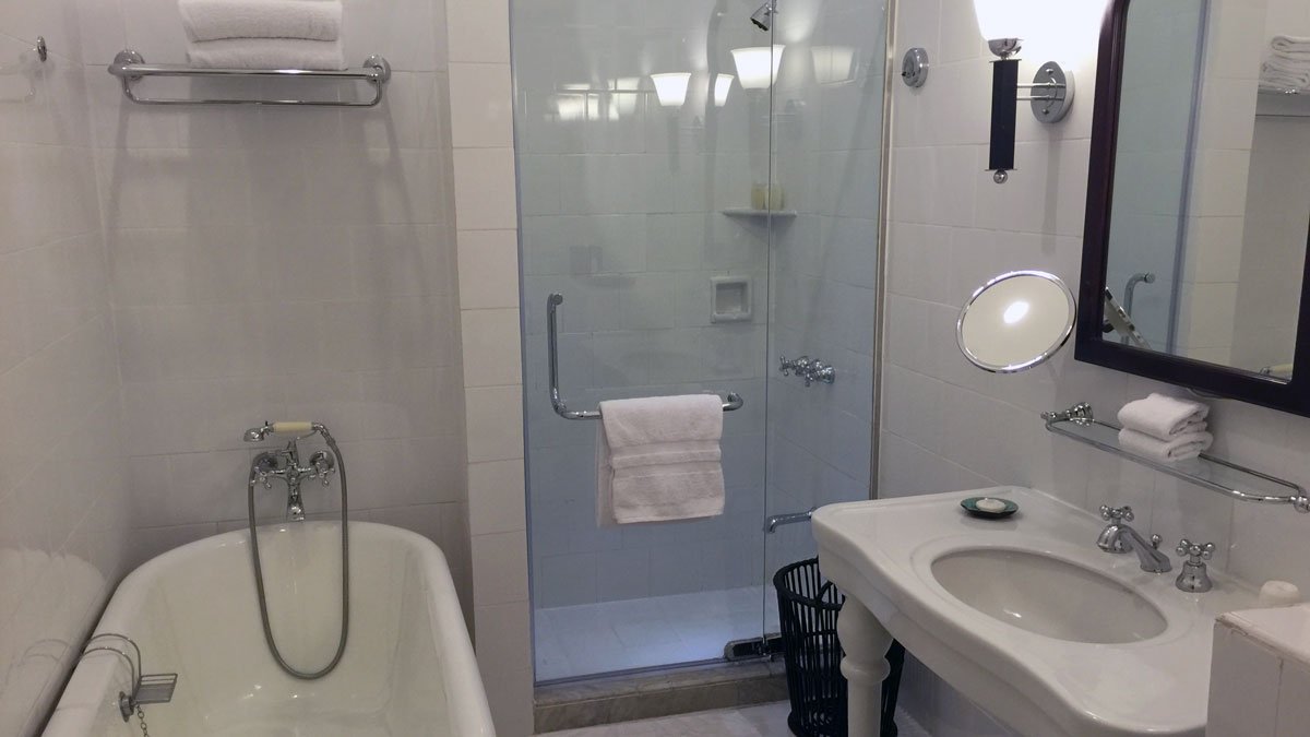 a bathroom with a glass shower door and sink