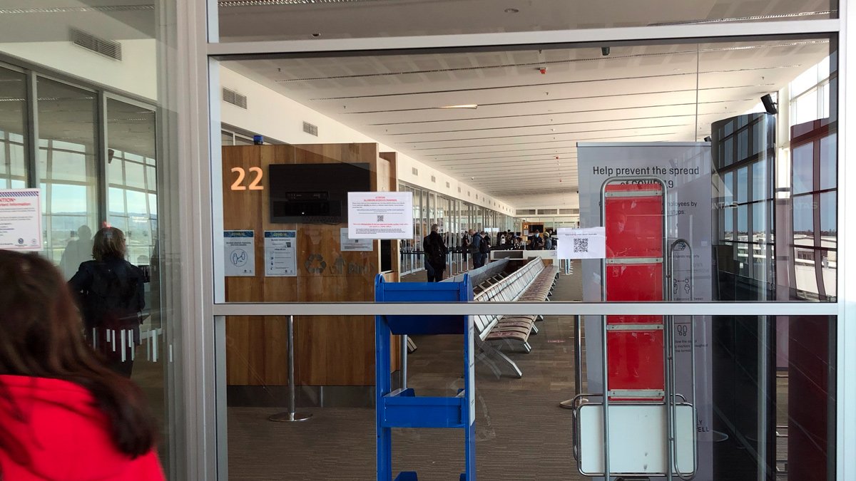 a glass door with a sign and a chair in a building