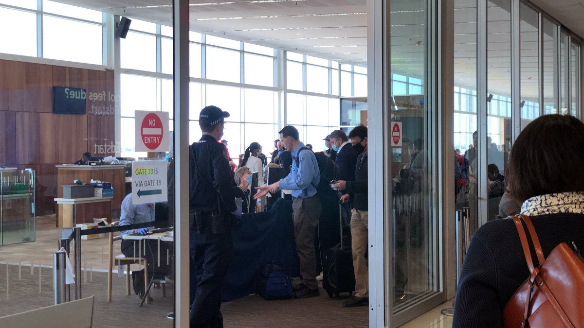 a group of people in a room with glass doors