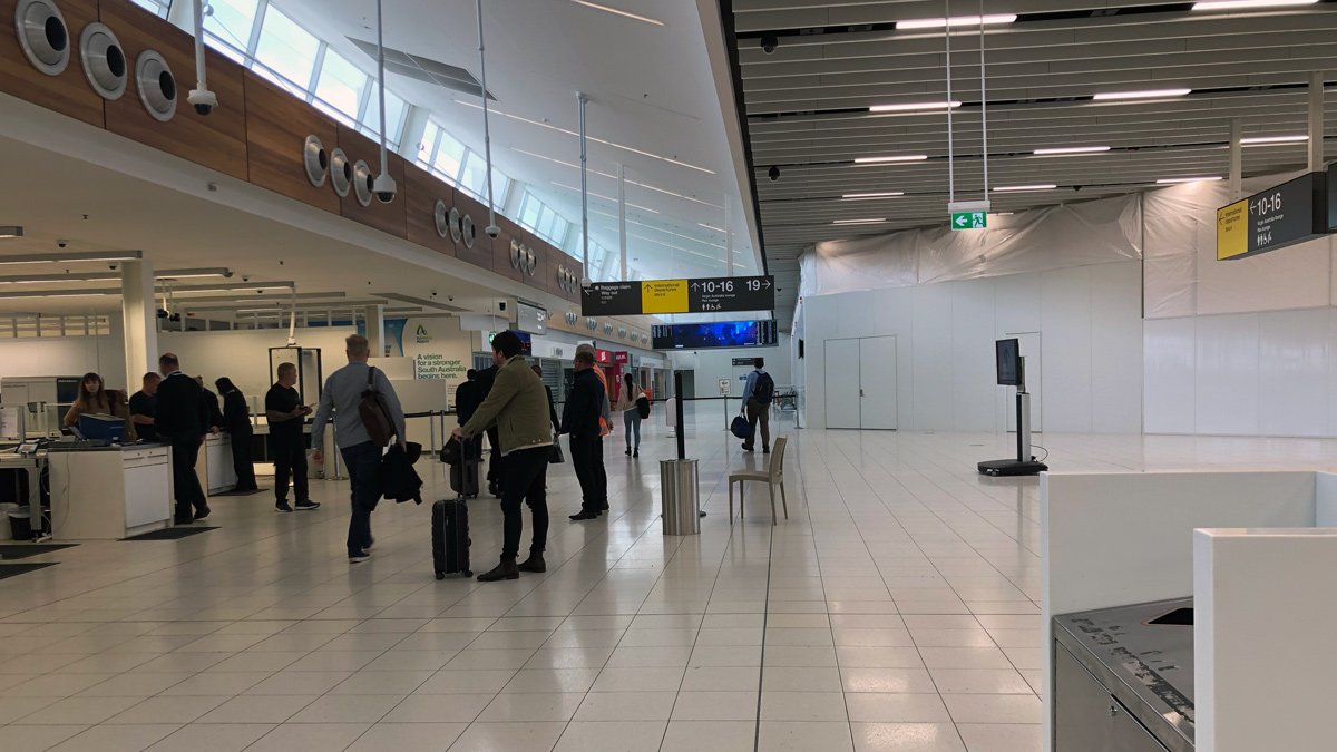 people in an airport with luggage