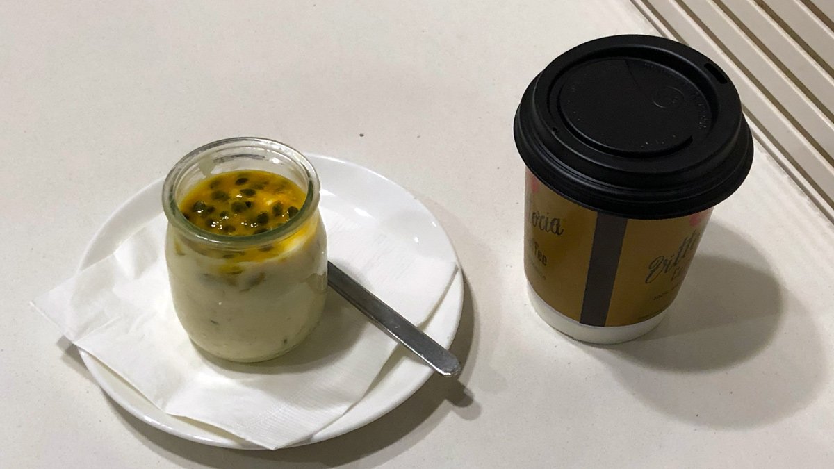 a glass jar with a spoon and a plate with food on it