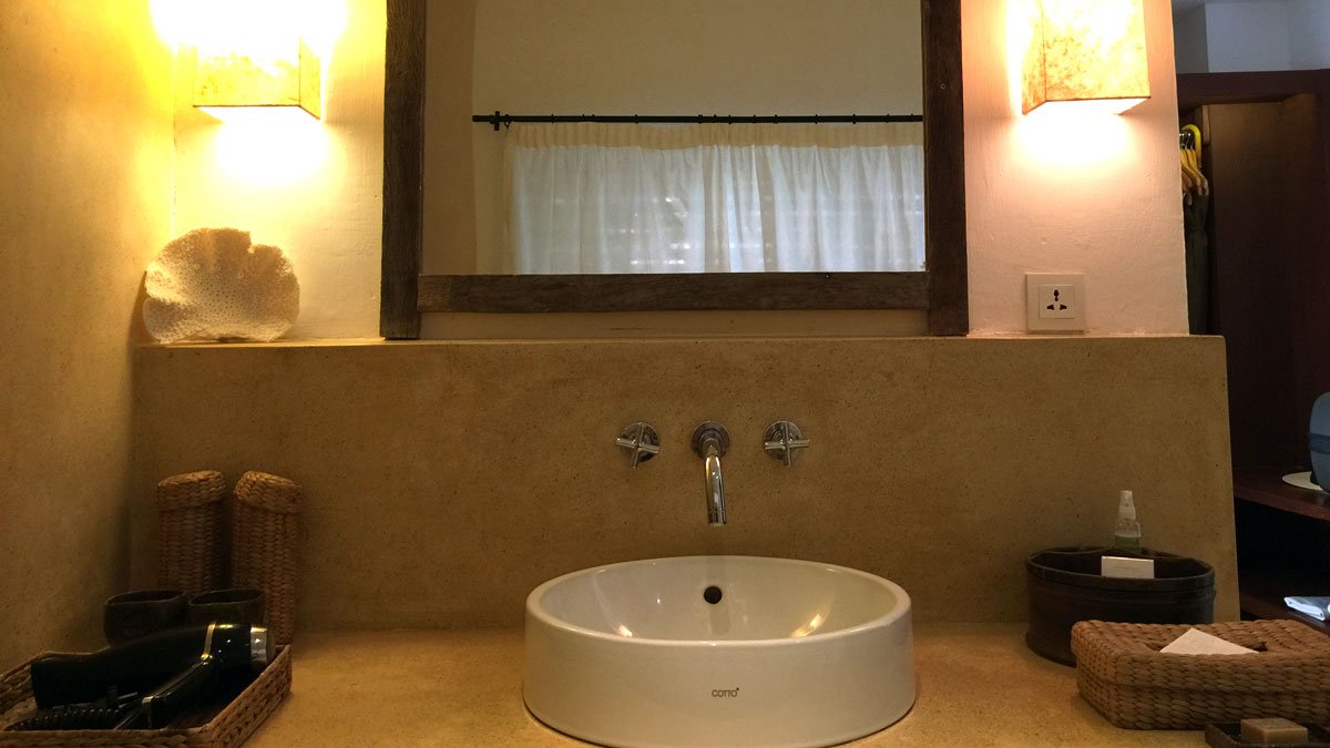 a bathroom sink with a mirror and a towel