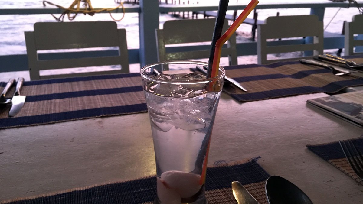 a glass of water with straws