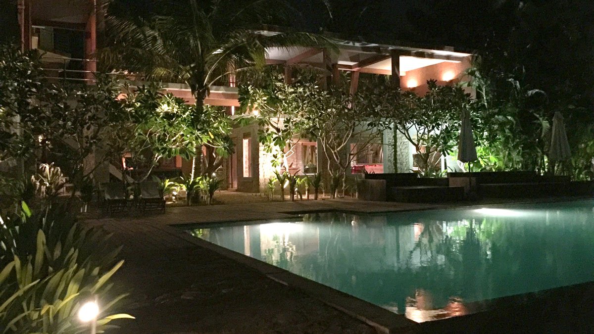 a pool and a building at night