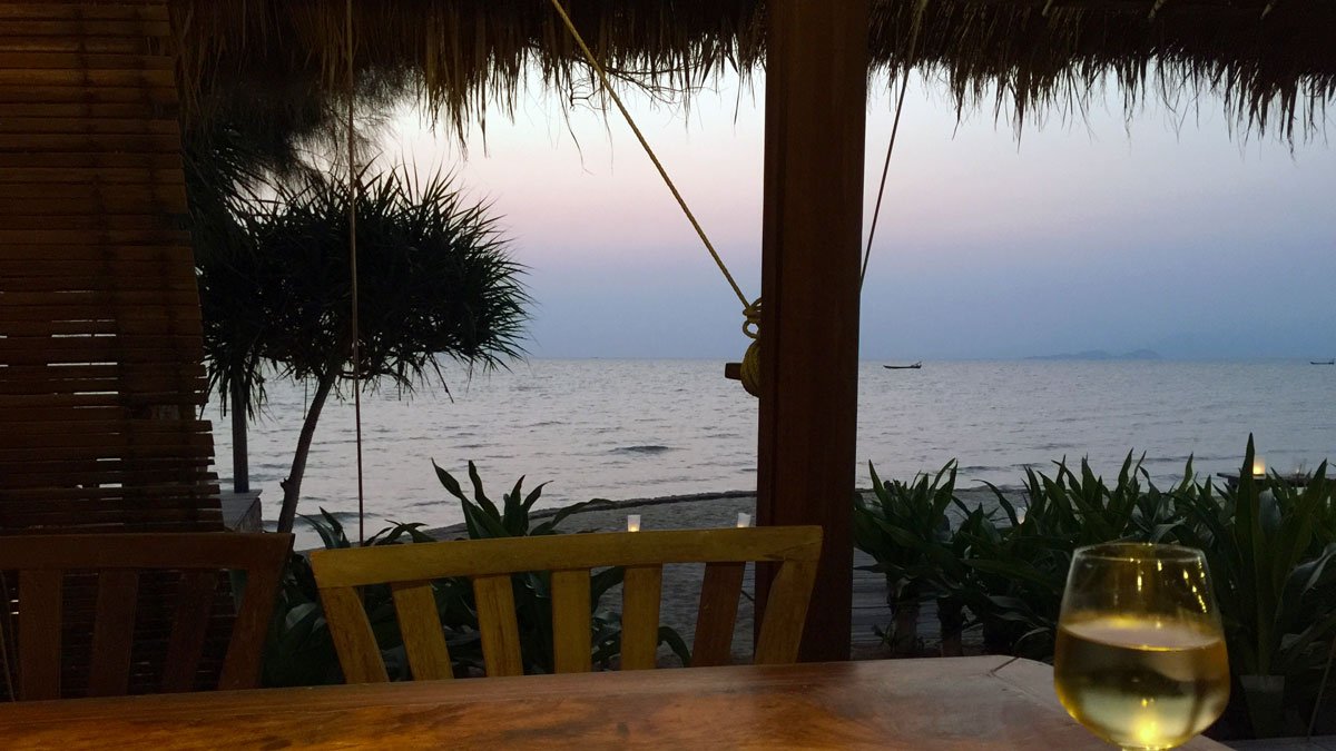 a table and chair by the ocean