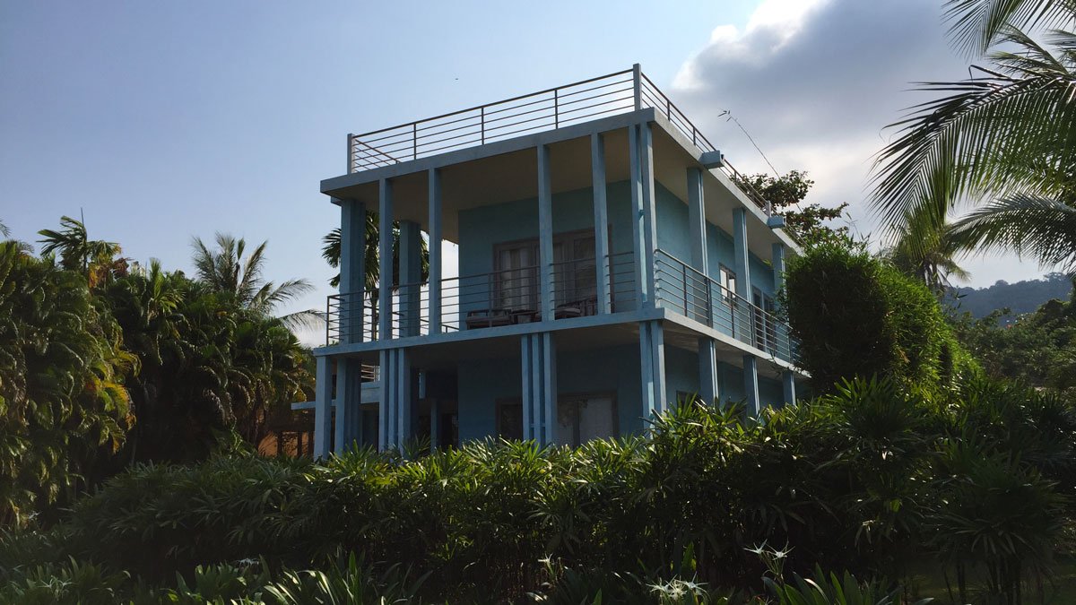 a building with a balcony and trees