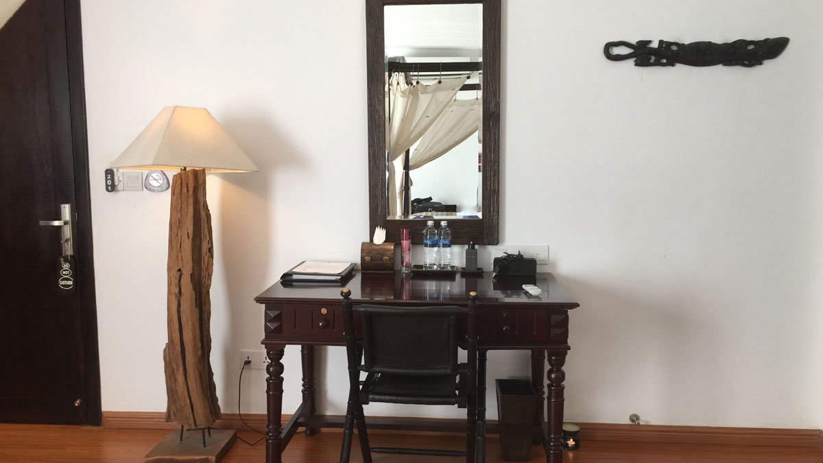 a desk with a chair and a mirror