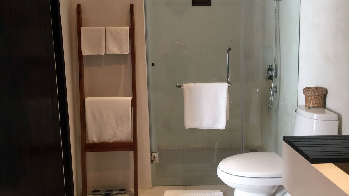 a bathroom with a glass shower door and toilet