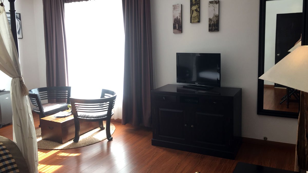 a room with a tv and chairs