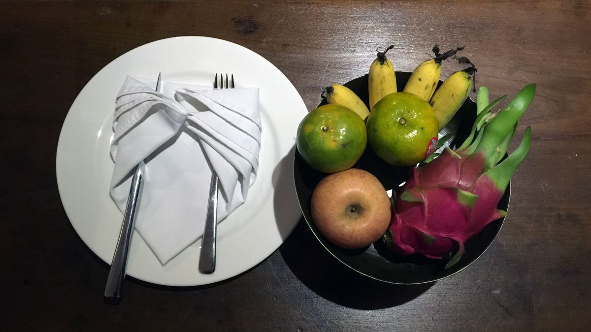 a plate with fruit and a napkin on it