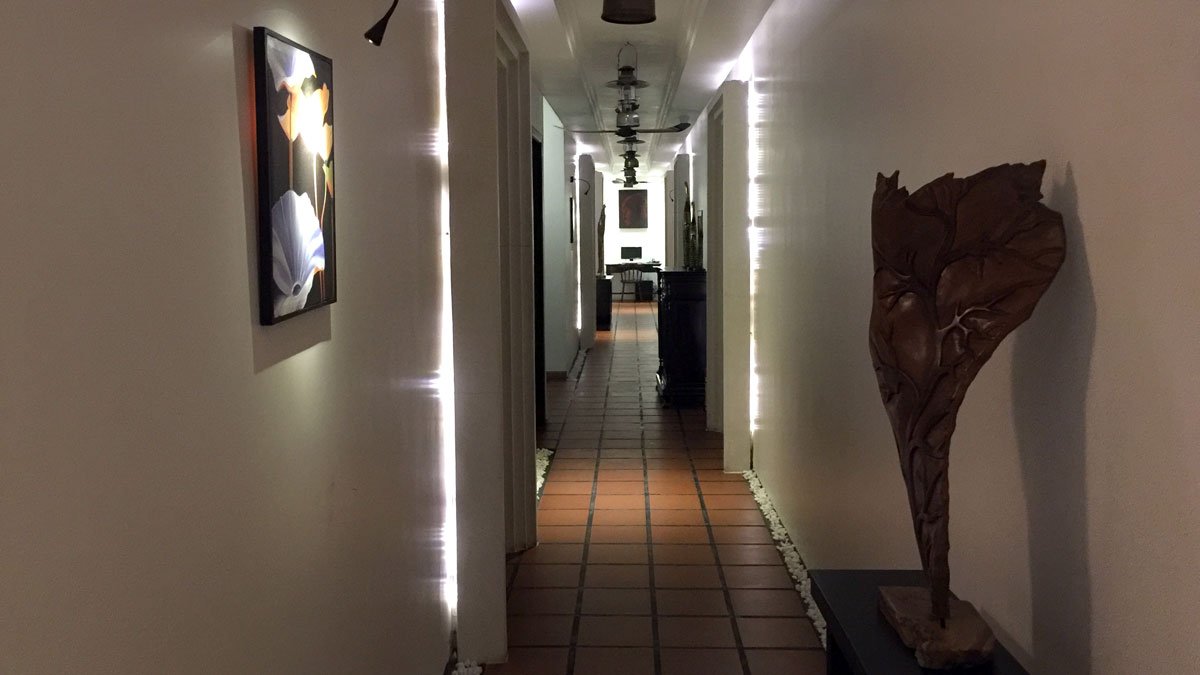 a hallway with a statue and artwork on the wall