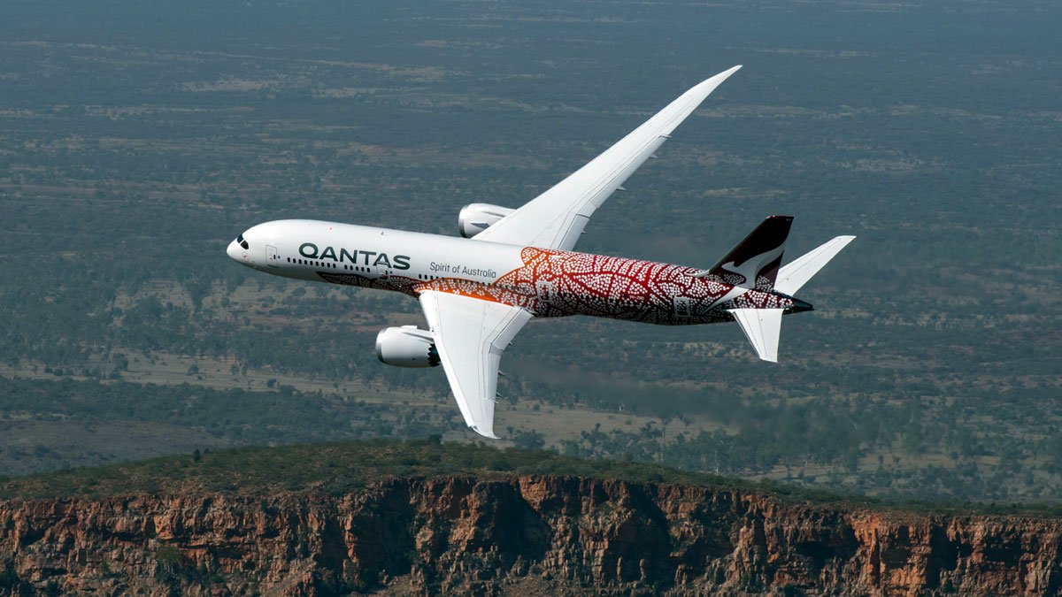 a plane flying over a cliff