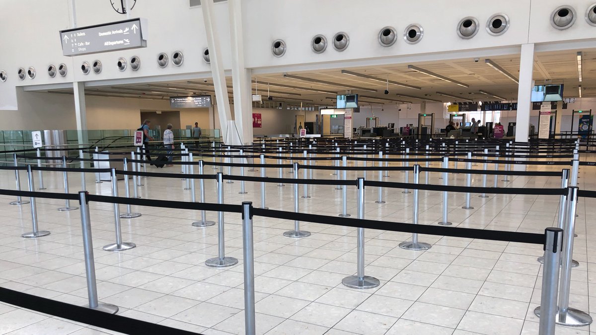 a row of black barriers in an airport