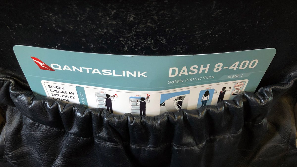 a black leather glove with a blue and white sign