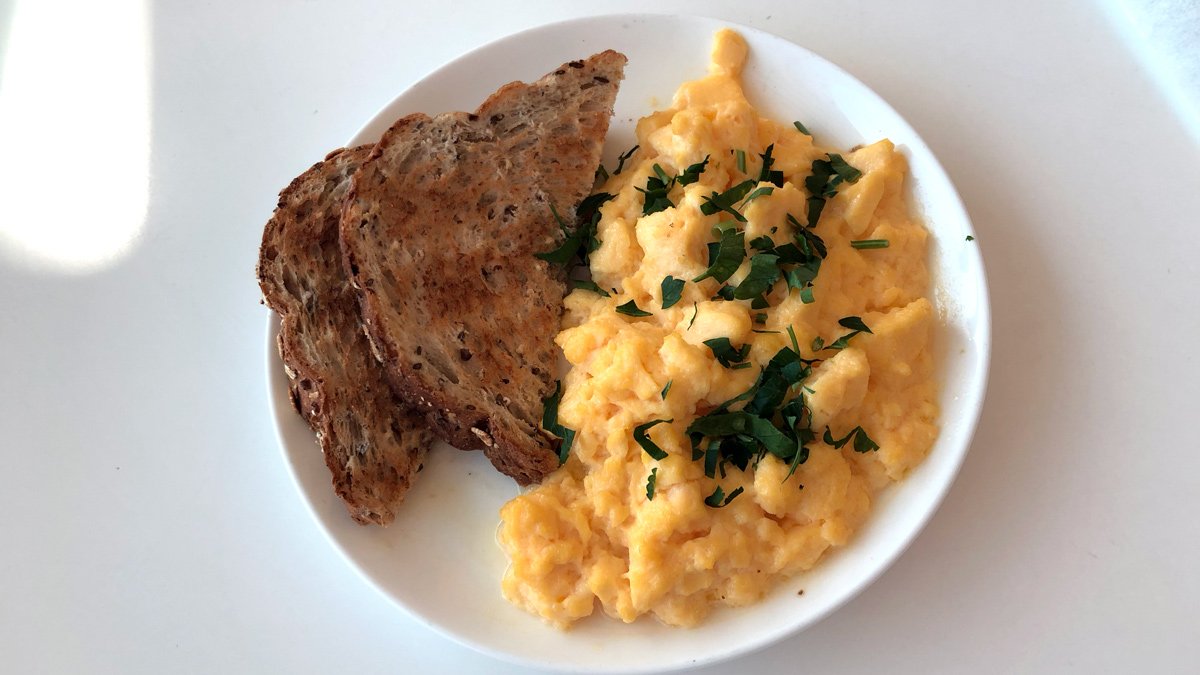 a plate of scrambled eggs and toast