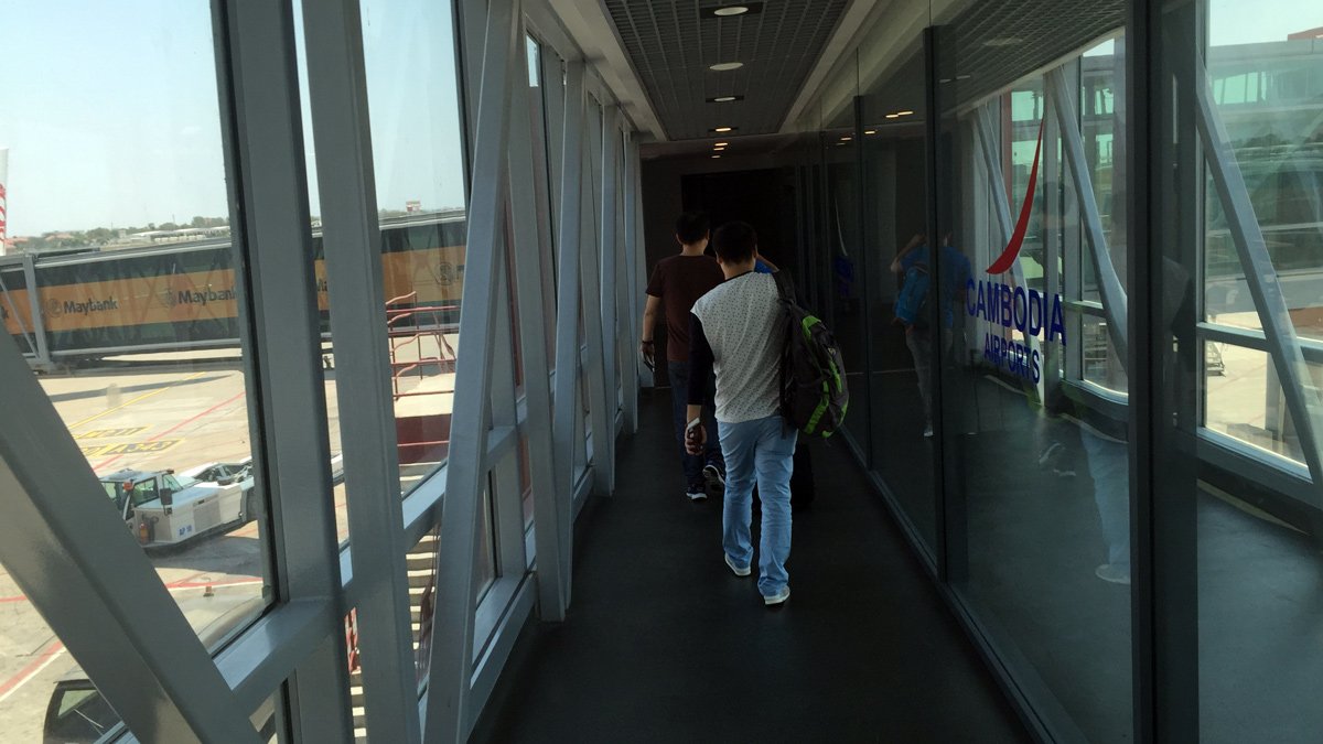 a group of people walking down a hallway