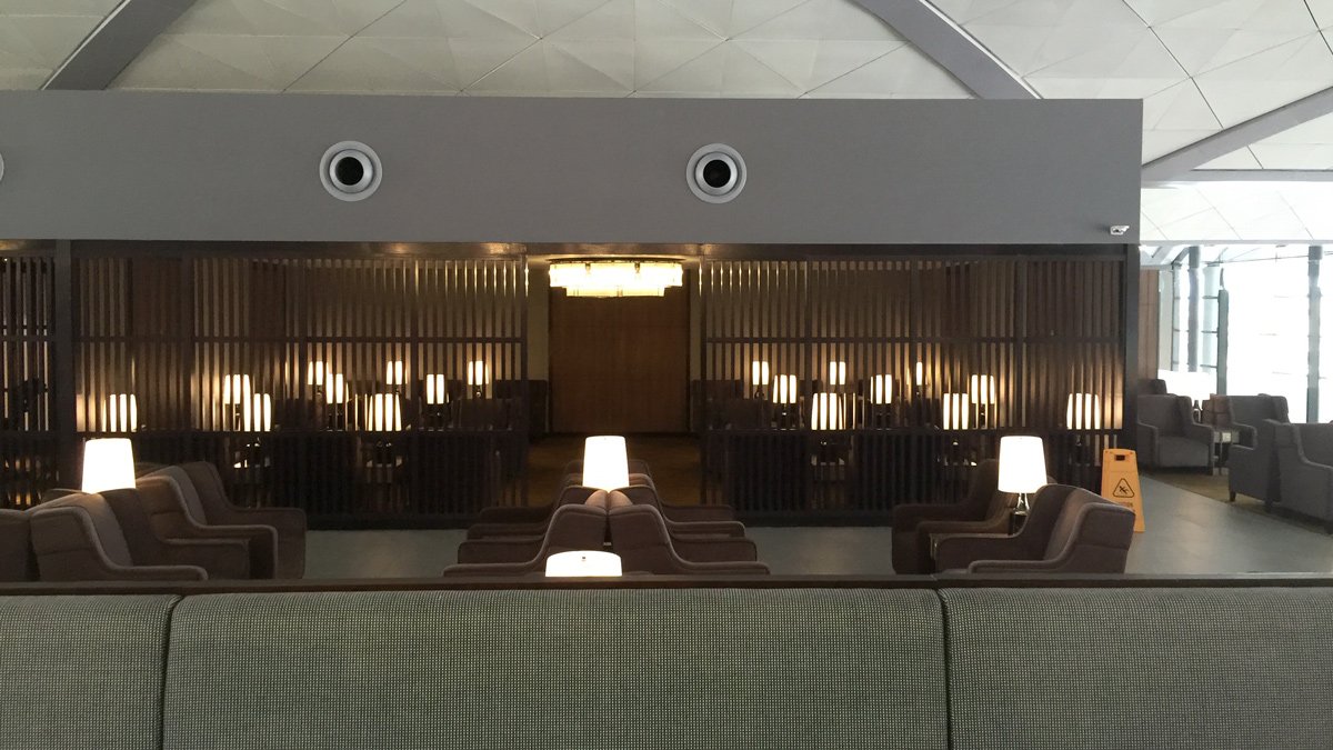 a room with a row of chairs and a wall with lights