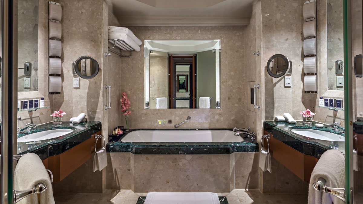 a bathroom with marble walls and a bathtub