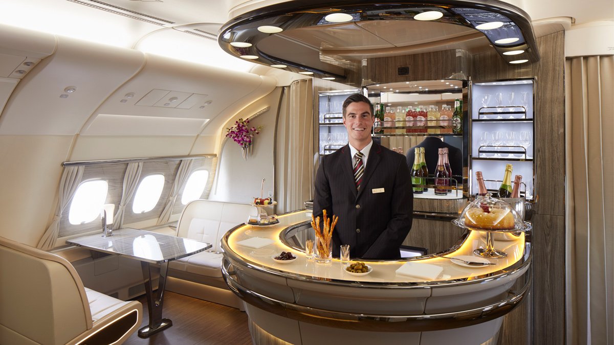 a man standing behind a bar in an airplane