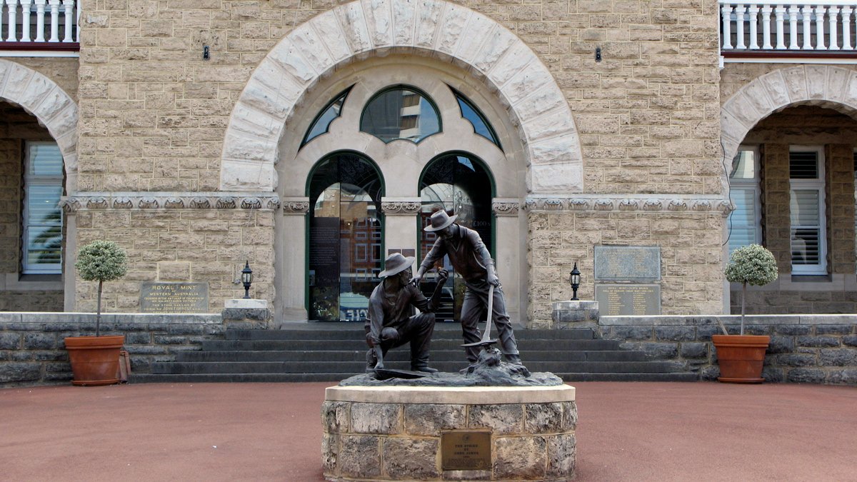 a statue of a man holding a shovel