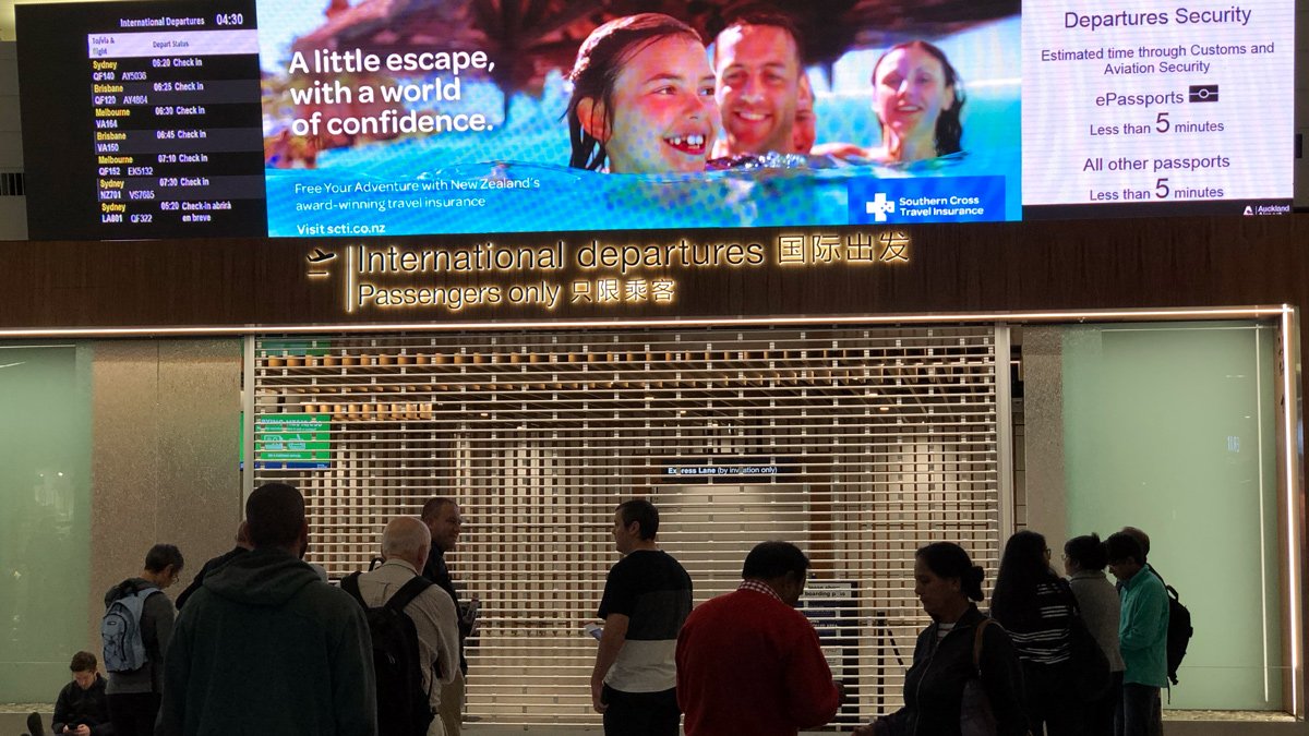 a group of people standing in front of a large screen