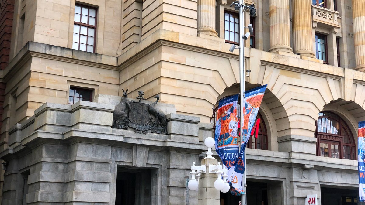 a flag on a pole in front of a building